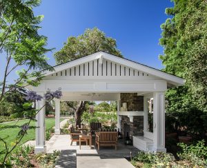 Covered Outdoor living space with a fireplace and seating area
